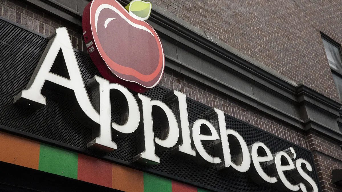 Applebee’s restaurant sign on building exterior. Applebee’s restaurant sign on building exterior.