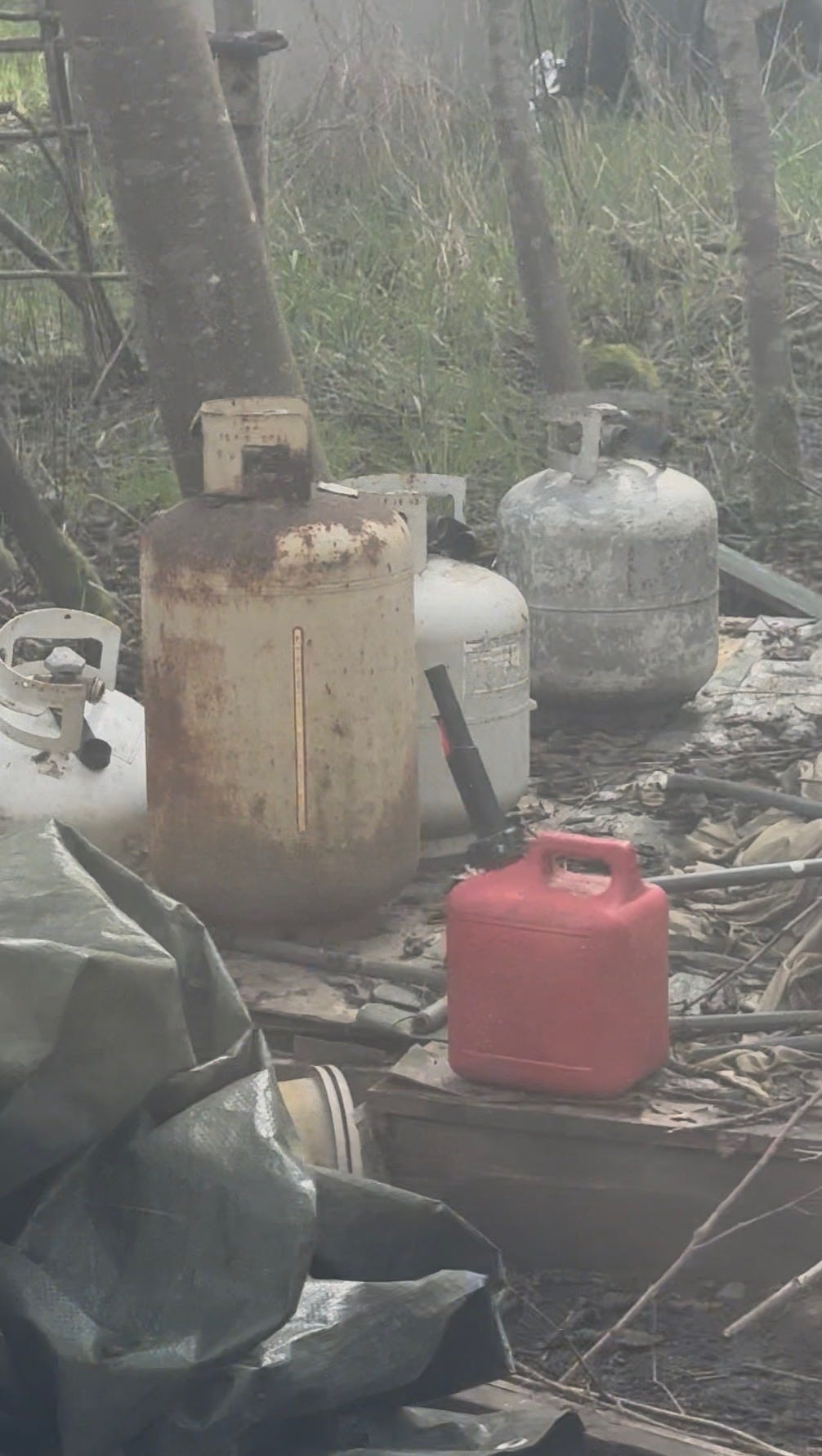 A group of gas cans in the woods
Description automatically generated A group of gas cans in the woods
Description automatically generated