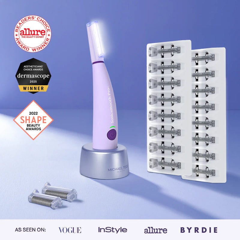 Lavender The Michael Todd Beauty Sonicsmooth Pro+ System shown in purple on a charging stand includes replacement heads, a blade pack, and displays beauty awards—perfect for sonic dermaplaning and professional exfoliation to remove peach fuzz.