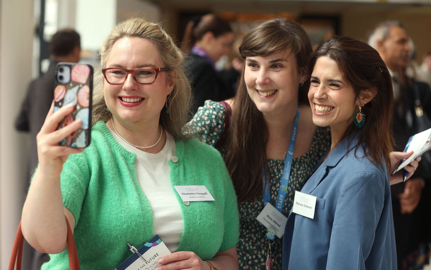 A photo of me taking a selfie with two of my former colleagues