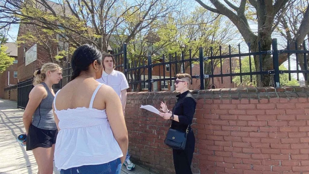 Undergraduate students (l to r) Emma Petite, Kamal Kuar, and
Matt Palmer listen to graduate student Emma Katherine Bilski, who
curated a walking tour about the orphanage as part of the class. Undergraduate students (l to r) Emma Petite, Kamal Kuar, and
Matt Palmer listen to graduate student Emma Katherine Bilski, who
curated a walking tour about the orphanage as part of the class.