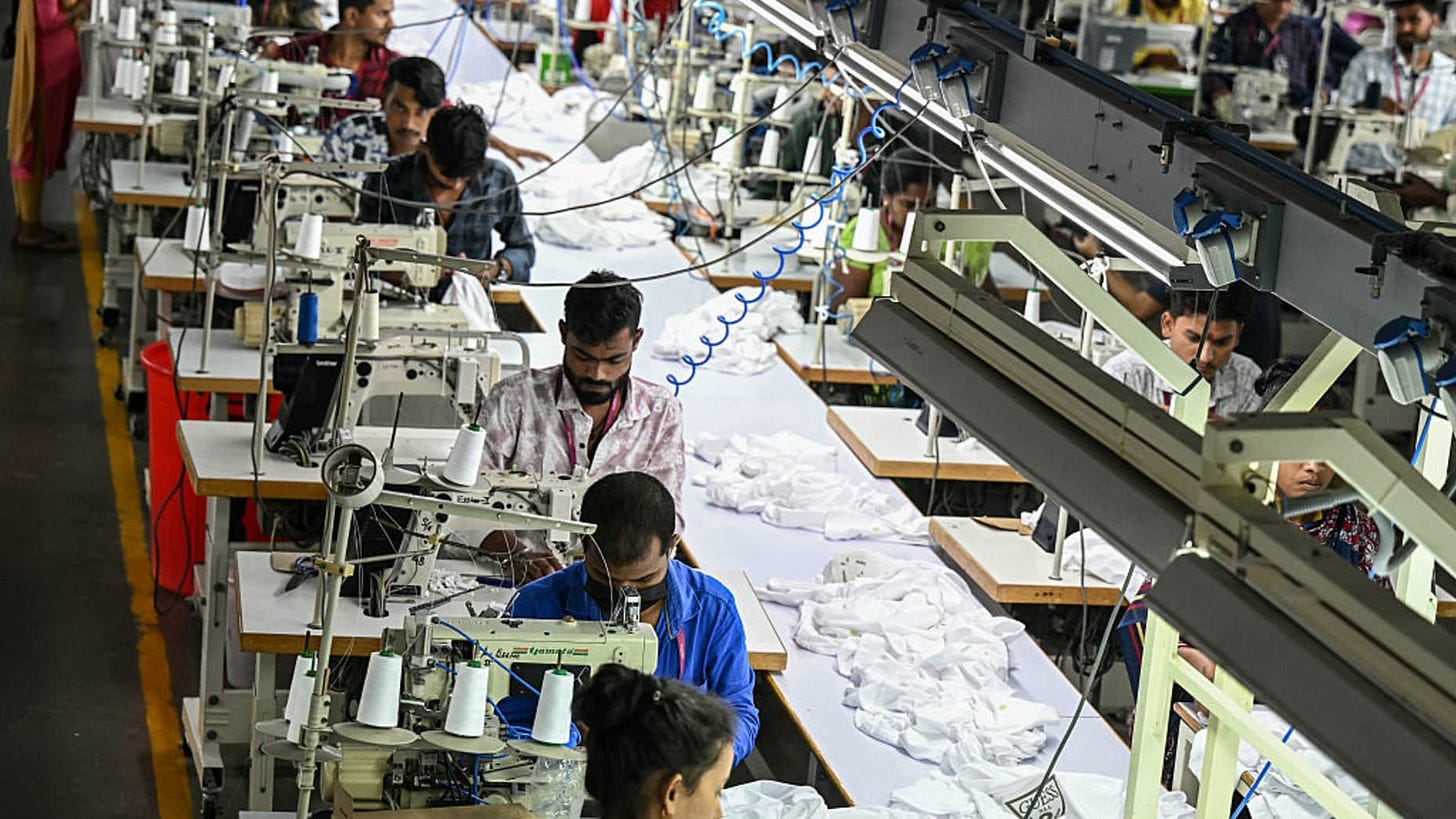 In this photograph taken on September 23, 2025, employees work at a garment factory in Tiruppur, in India's southern state of Tamil Nadu. Trump's 50 percent tariffs on Indian goods, imposed in August, have upset the country's $11 billion textile export industry and shaken confidence in the US market. (Photo by R. Satish BABU / AFP) / To go with 'India-US-Tariff-Trade-Textile' , FOCUS by Anuj SRIVAS (Photo by R. SATISH BABU/AFP via Getty Images)          