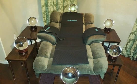 Image of a recliner surrounded by clear orbs on nightstand tables Image of a recliner surrounded by clear orbs on nightstand tables