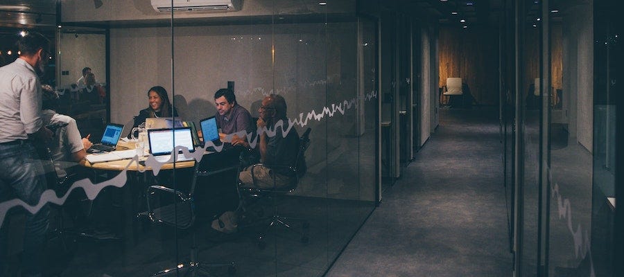 People in glass conference room
