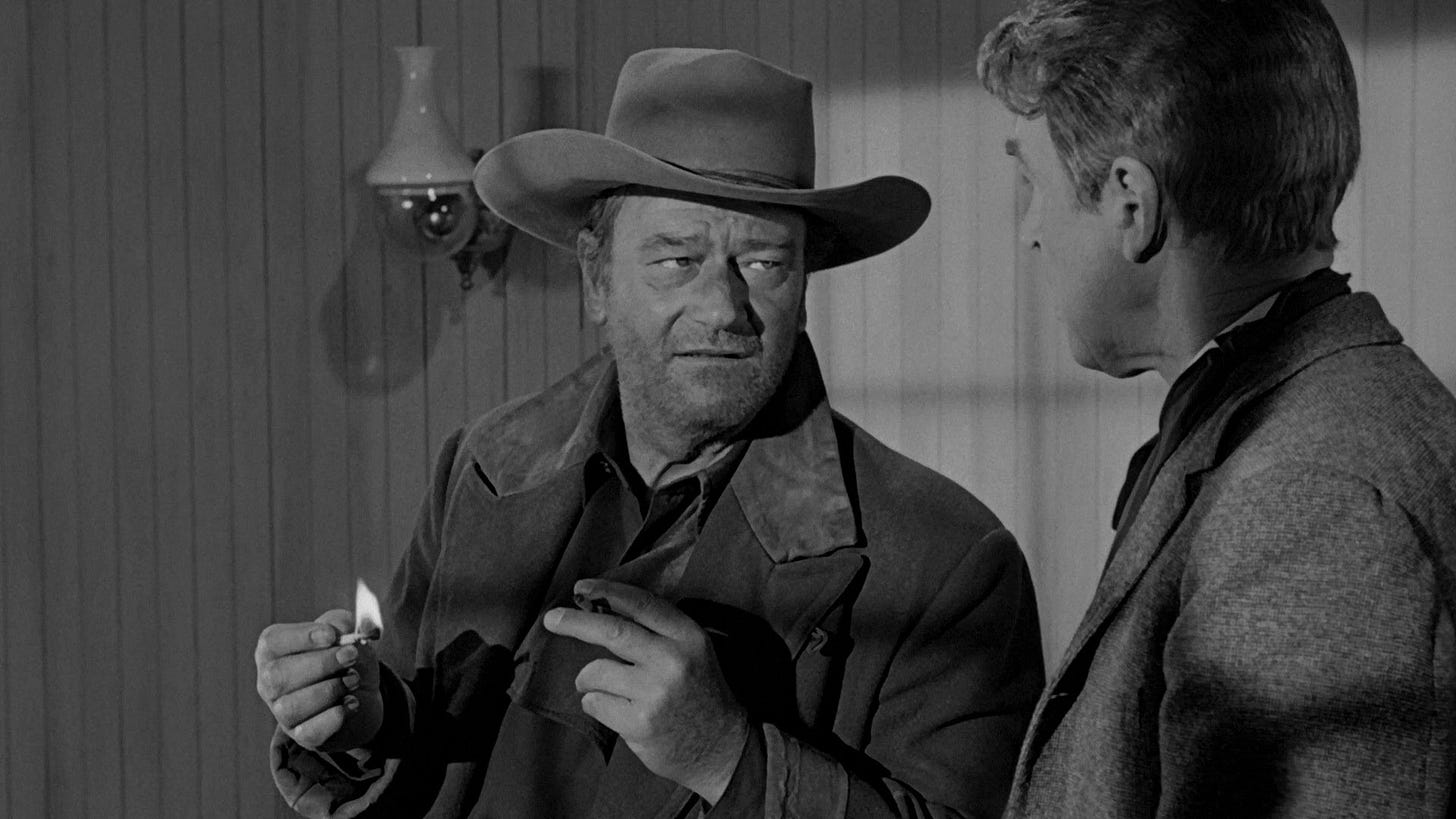 The Man Who Shot Liberty Valance | Still features John Wayne as Tom Doniphon looking directly at James Stewart as Ransom Stoddard.