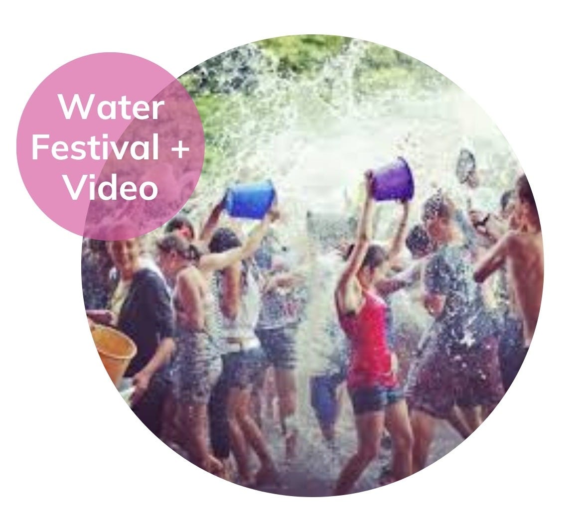 Celebration of Vardavar in Armenia with large group throwing water on one another, young woman in red tank top, shorts, and purple bucket the focus