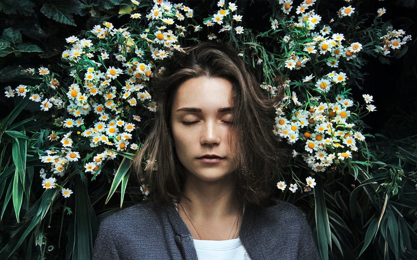 Woman relaxing in a bed of flowers