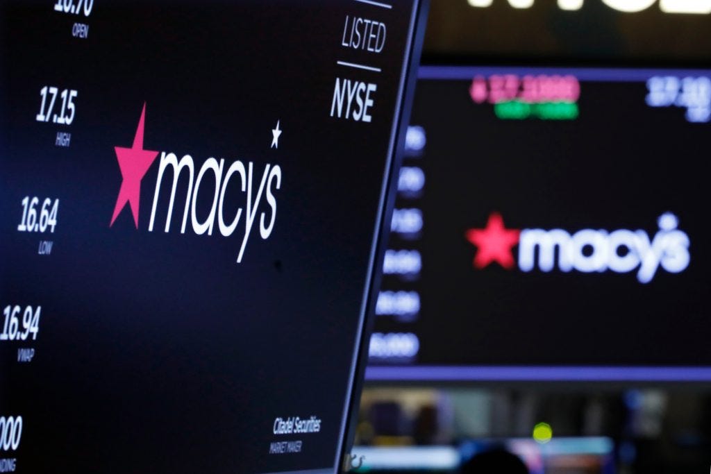The logo for Macy's appears above posts on the floor of the New York Stock Exchange, . Macy's rose 2.9 percent after the department store giant said it will cut 2,000 corporate jobs and close 125 of its least productive storesFinancial Markets Wall Street Macy's, New York, USA - 05 Feb 2020