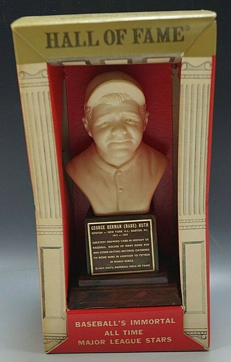 A few of the items from Mr. Mertle's Curio Cabinet, including a Cleveland Indians pennant, 1955's Greatest Moments in Sports record, several 1963 Sports Hall of Fame busts, and a framed color print of the 1866 Currier & Ives lithograph "The American National Game of Base Ball: Grand Match for the Championship at the Elysian Fields, Hoboken, N. J."