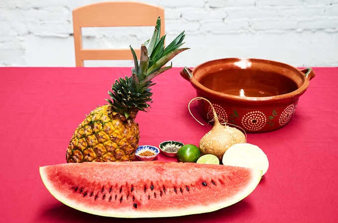 ingredients on table to make spicy Mexican fruit salad