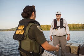 game warden checking fishing boat