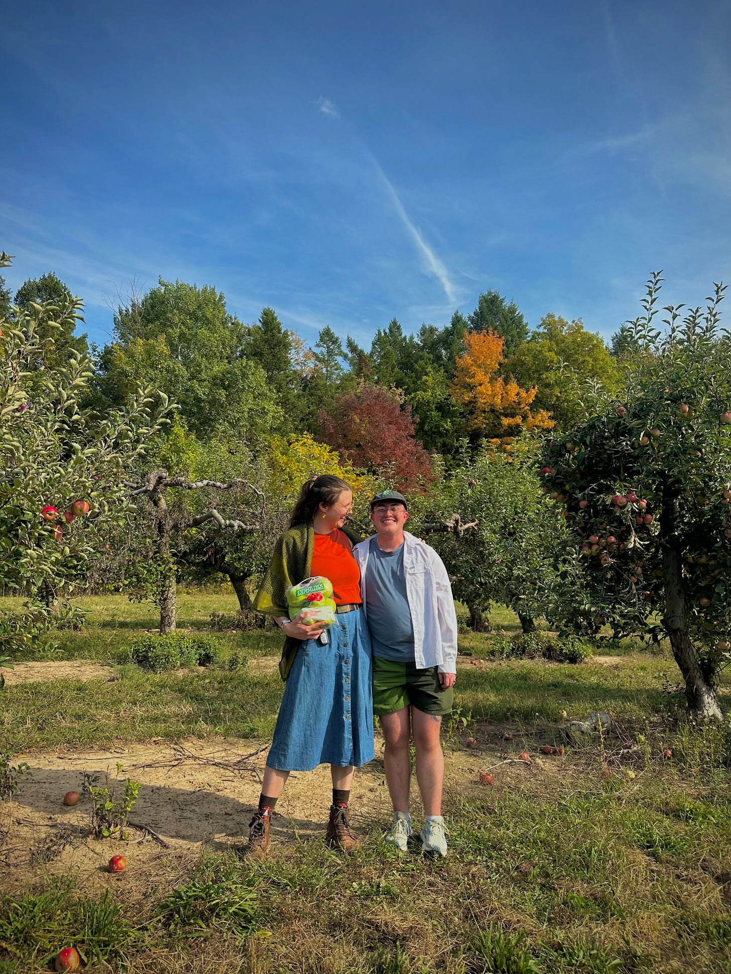 Jozef and Emory enjoying some autumnal fun—posing for a picture between picking apples at a local orchard. 