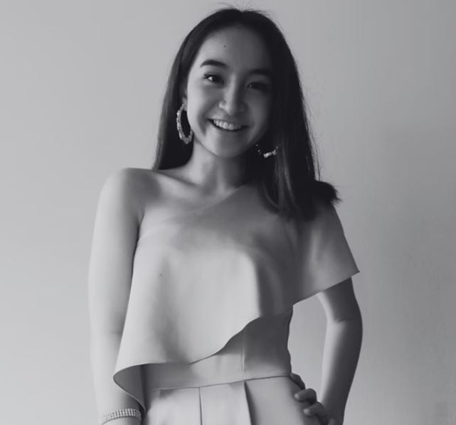 A person smiling with her hands on her hips

Description automatically generated