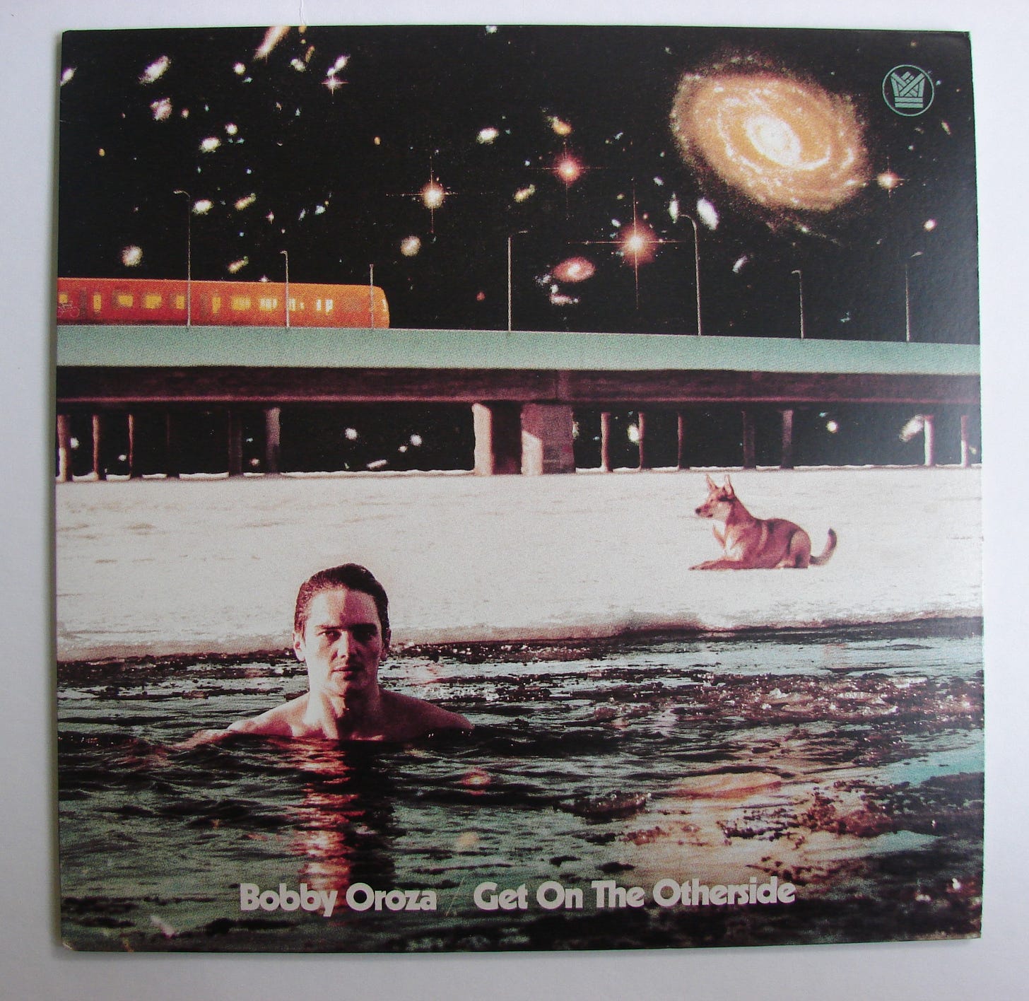 a trippy album cover for Get on the Otherside by Bobby Oroza. the musician appears in water towards the bottom of the image. a dog rests on the sand behind him. a glowing orange train passes in the background, and there are many shining stars in the night sky. a trippy album cover for Get on the Otherside by Bobby Oroza. the musician appears in water towards the bottom of the image. a dog rests on the sand behind him. a glowing orange train passes in the background, and there are many shining stars in the night sky.