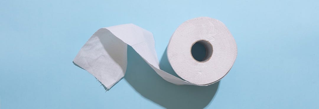 white toilet paper roll on white table