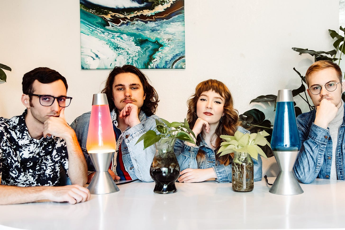 four people sitting at indoor table