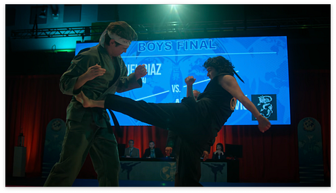 Johnny breaking blocks, Miyagi-do on stage, Miguel vs Axel
