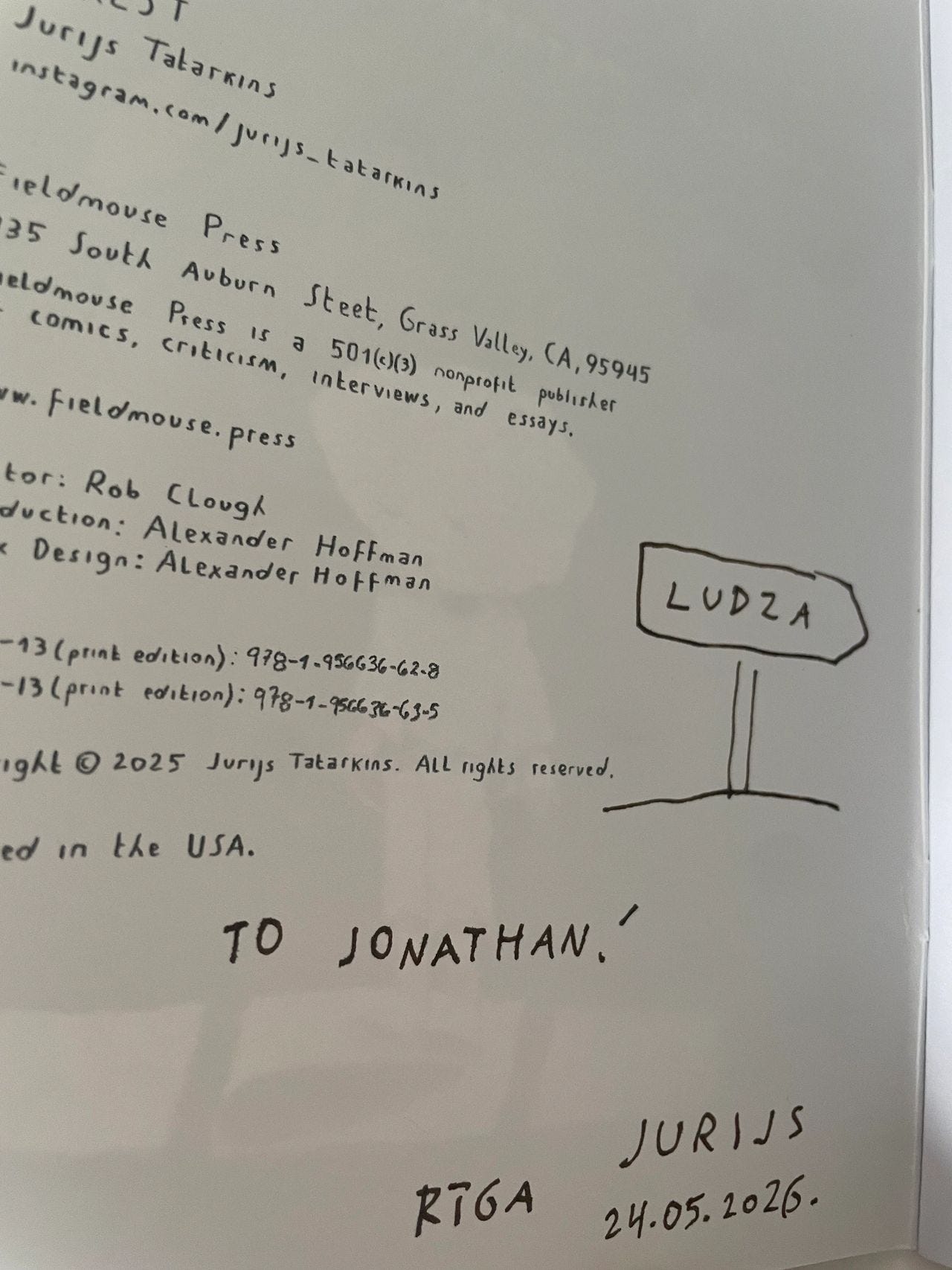 Jurijs signing my copy of Unrest with a reference to Ludza — the town I was due to visit the next day, where my family lived in the early 20th century. Jurijs signing my copy of Unrest with a reference to Ludza — the town I was due to visit the next day, where my family lived in the early 20th century.