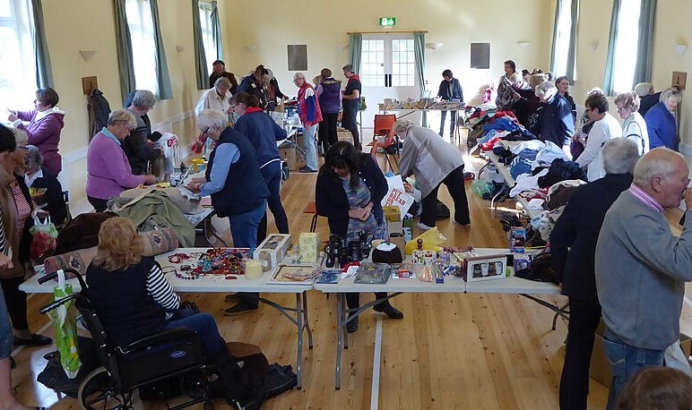 Men and women at a rummage sale Men and women at a rummage sale