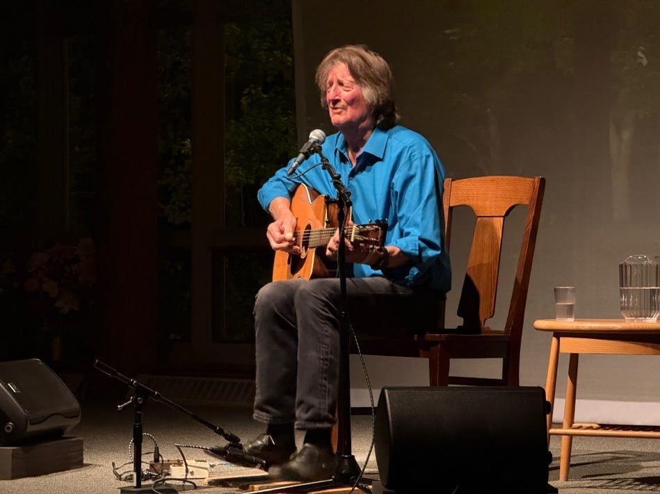 A person sitting in a chair playing a guitar

AI-generated content may be incorrect.