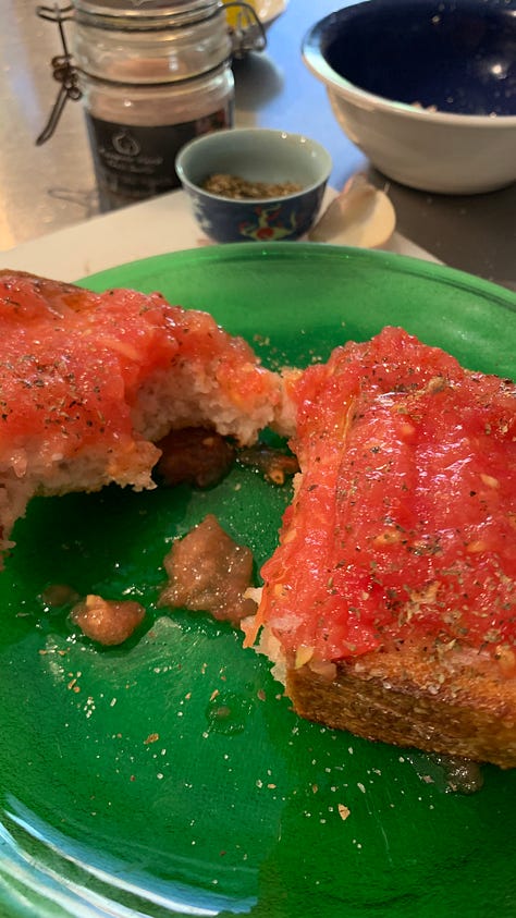 Image shows a green glass plate with a slice of bread smothered in pulped fresh tomato