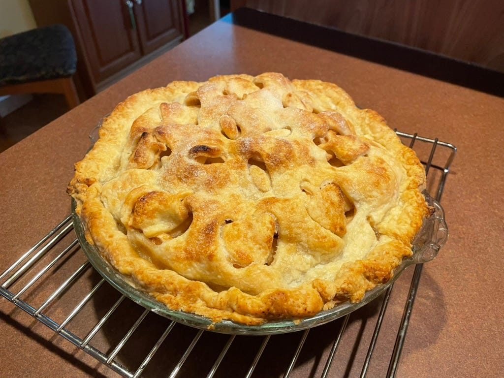A pie on a cooling rack

AI-generated content may be incorrect.