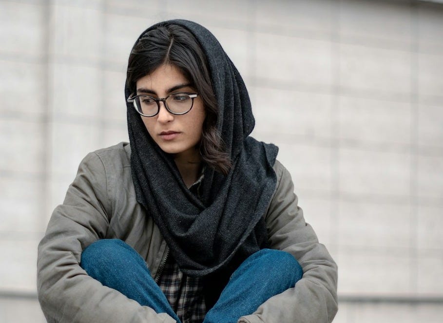 woman in blue denim jacket and black hijab