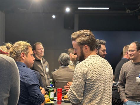 Participants networking, listening to talks, and discussing agents and data engineering during a community night at Google.