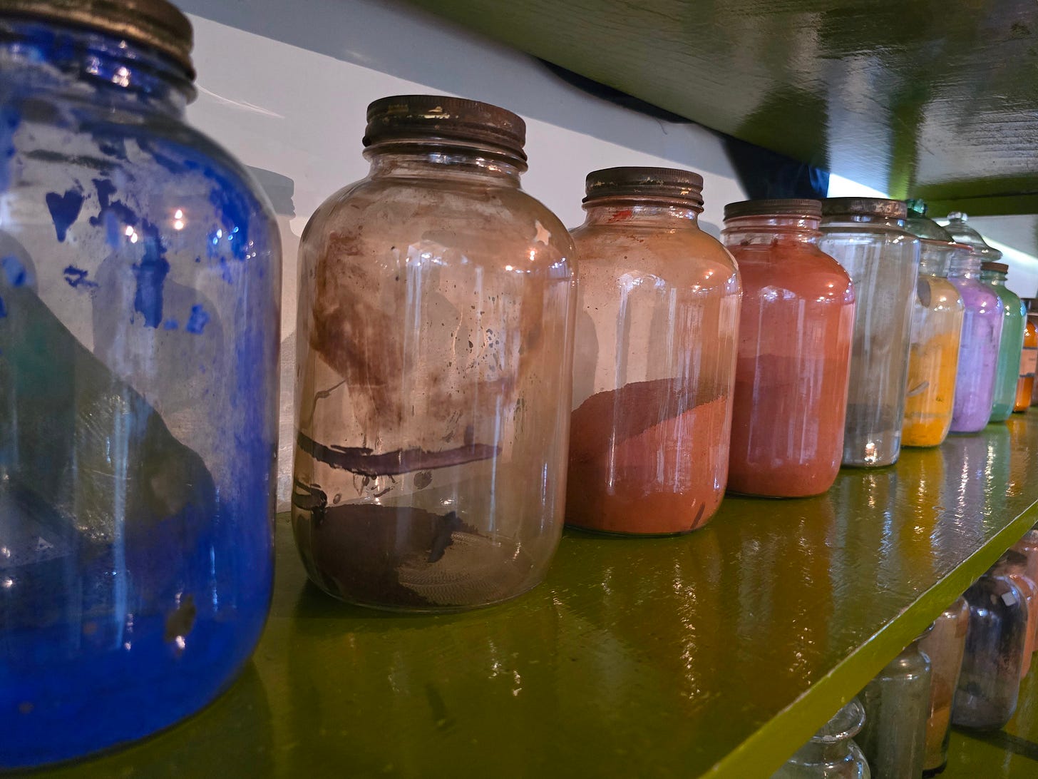 Jars full of pigment line shelves in the Diego Rivera y Frida Kahlo studio museum.
