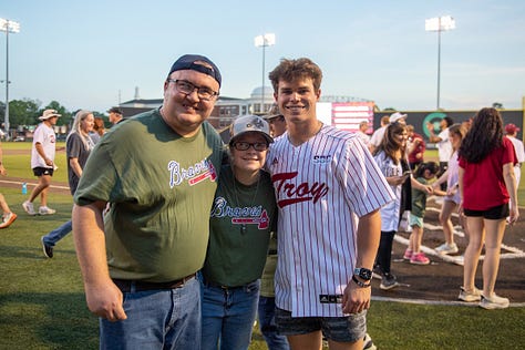 TROY student-athletes help celebrate opening night of the Miracle League with Miracle League players on Monday night at Riddle-Pace field. The Troy Miracle League in Troy, Alabama, provides children and adults of all ages with disabilities the opportunity to play baseball, and have fun. (Photos/Joey Meredith)