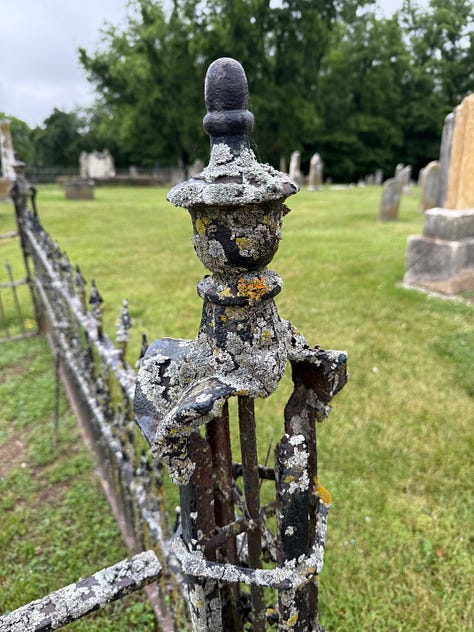 The first image is a fence finial, mossy and rusted down. The last is a lone grave stone as far into the corner as you can get. And I thought the middle shot of a family site was interesting. Those stones aren't going to sink!