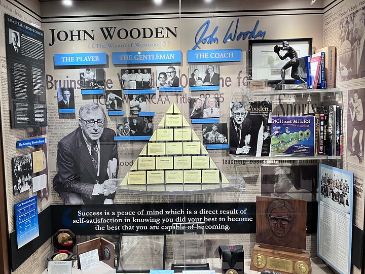Image of John Wooden stamps and the Pyramid of Success, at the Morgan Center Hall of Fame at UCLA