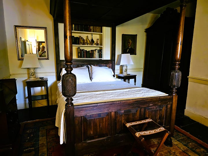 Bedroom shots, showing high four poster beds with Oriental rugs on the floor.