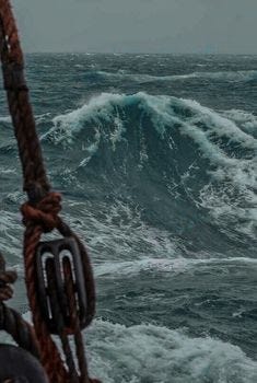 This may contain: a boat in the ocean with large waves