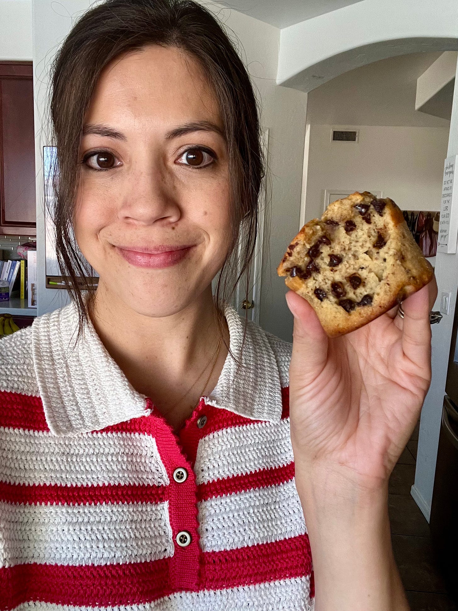 Abby holding chocolate chip muffin.
