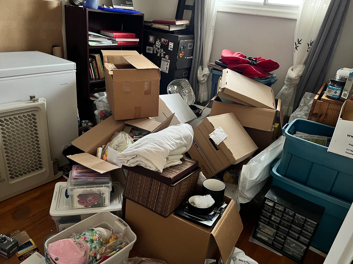 Overflowing boxes precariously piled with stuff overflowing.