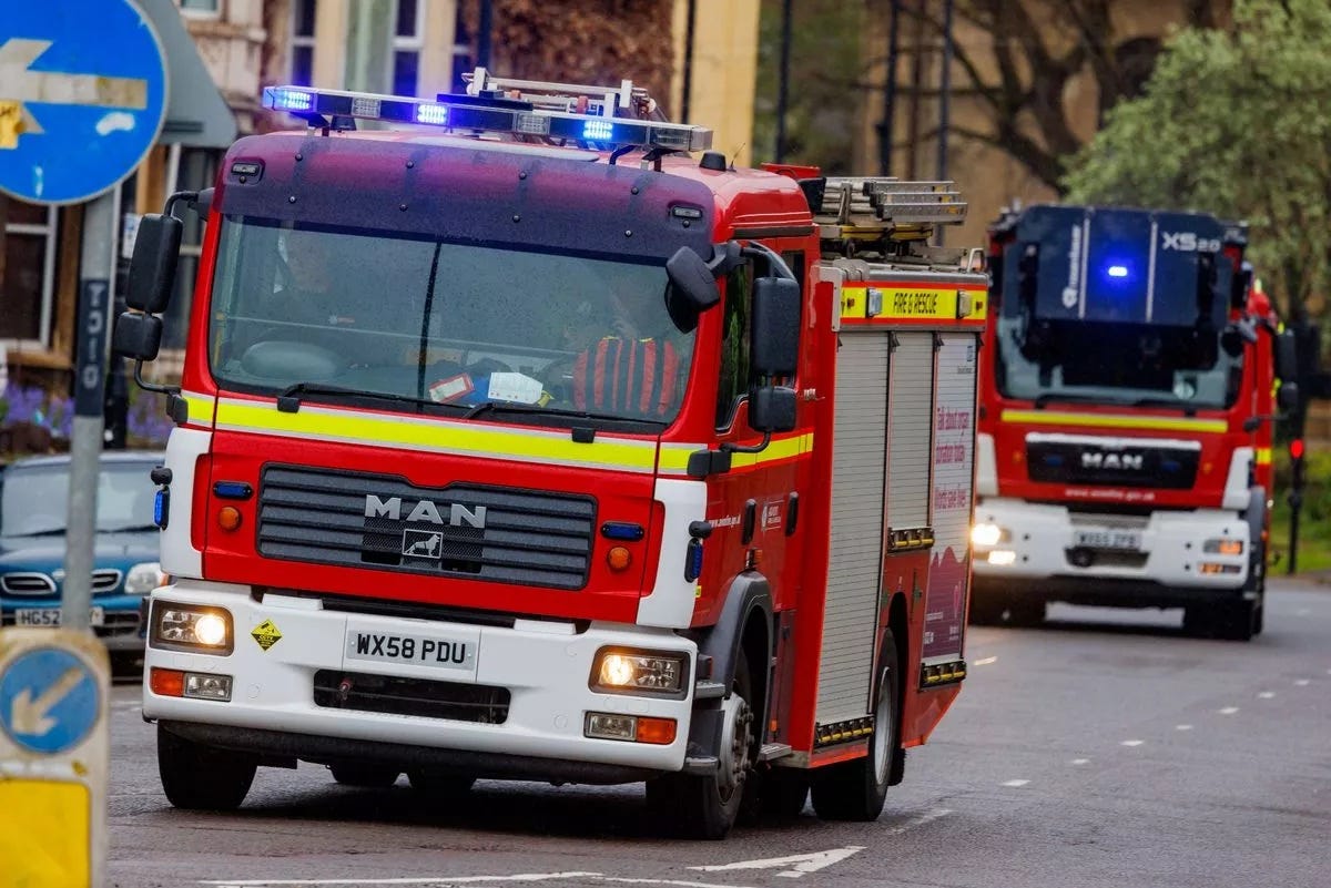 Avon Fire and Rescue Service fire engines responding to emergency call in Bristol, showing multiple fire appliances navigating urban streets with traffic management signage visible Image: Bristol Live. Avon Fire and Rescue Service fire engines responding to emergency call in Bristol, showing multiple fire appliances navigating urban streets with traffic management signage visible Image: Bristol Live.