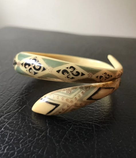 Stylized snake forms beginning in horn or shell are remade in early plastic approximations of natural materials.