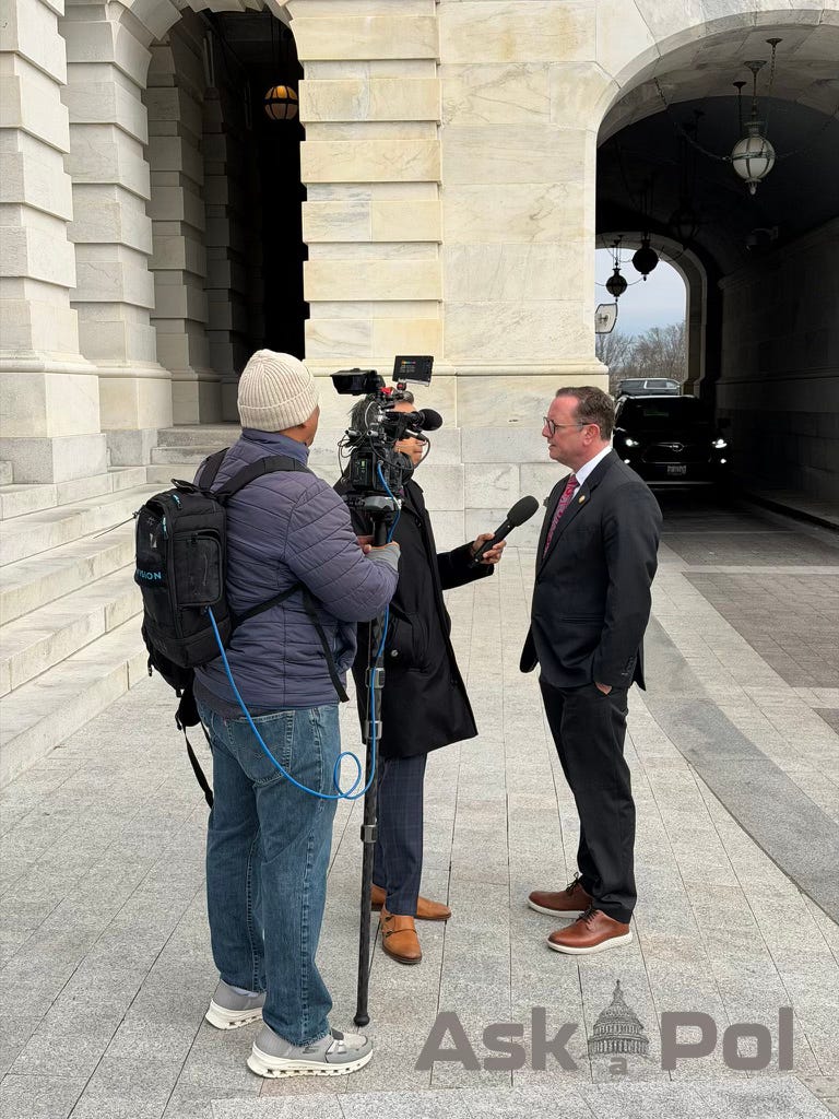 A camera crew records a man in a suit answering their questions outside the US Capitol. Photo: Matt Laslo © www.askapolpolitics.com