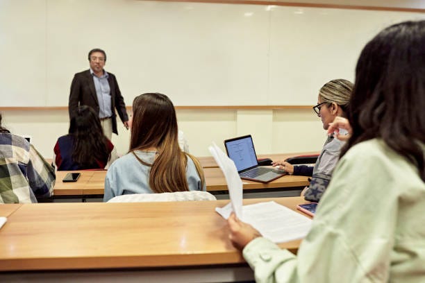 Early 40s male instructor giving lecture in university class
