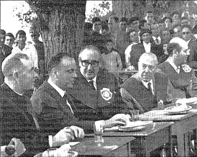 Manuel Fraga, Minister of Tourism (2nd from left) converses with Àlvaro Cunquerio (center), writer and poet Manuel Fraga, Minister of Tourism (2nd from left) converses with Àlvaro Cunquerio (center), writer and poet