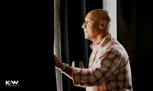 Kevin W Williams side profile looking out a window while drinking coffee. Kevin W Williams side profile looking out a window while drinking coffee.