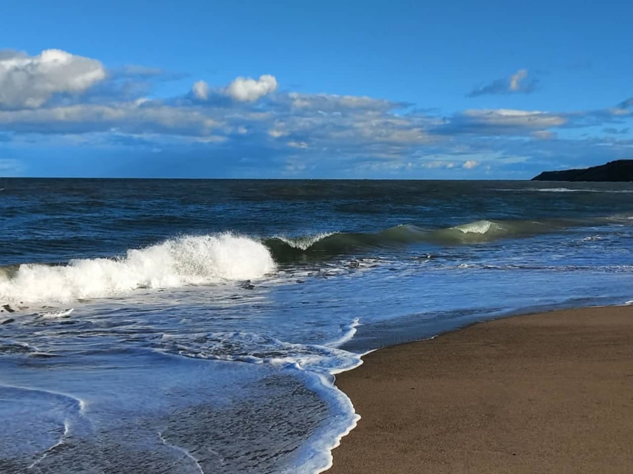 Waves crashing on a sandy beach Waves crashing on a sandy beach