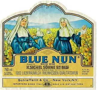 The Blue Nun label, depicting nuns in blue habits harvesting yellow grapes in a vineyard with mountains visible in the distance. 