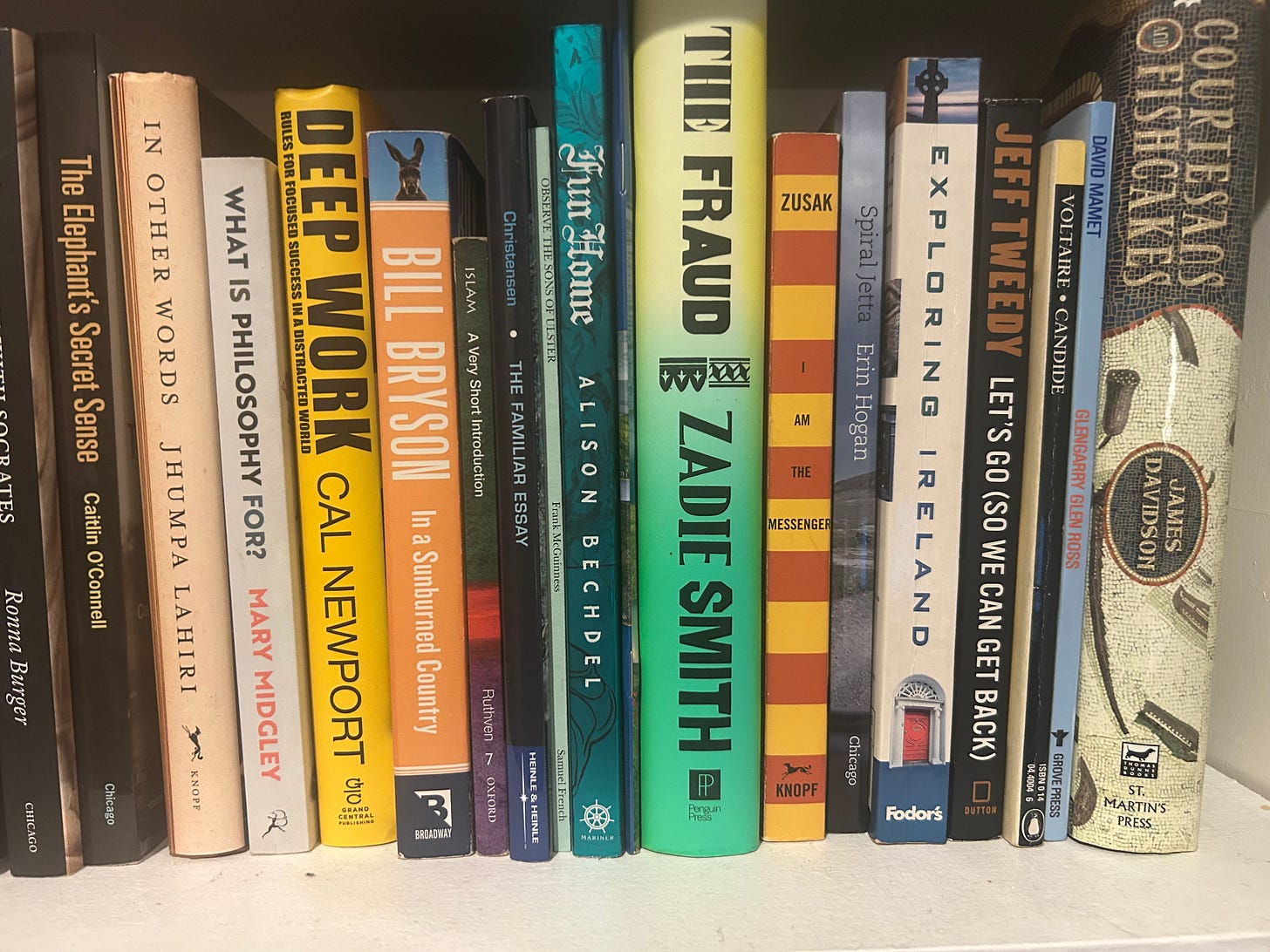A shelve of books in multiple categories.