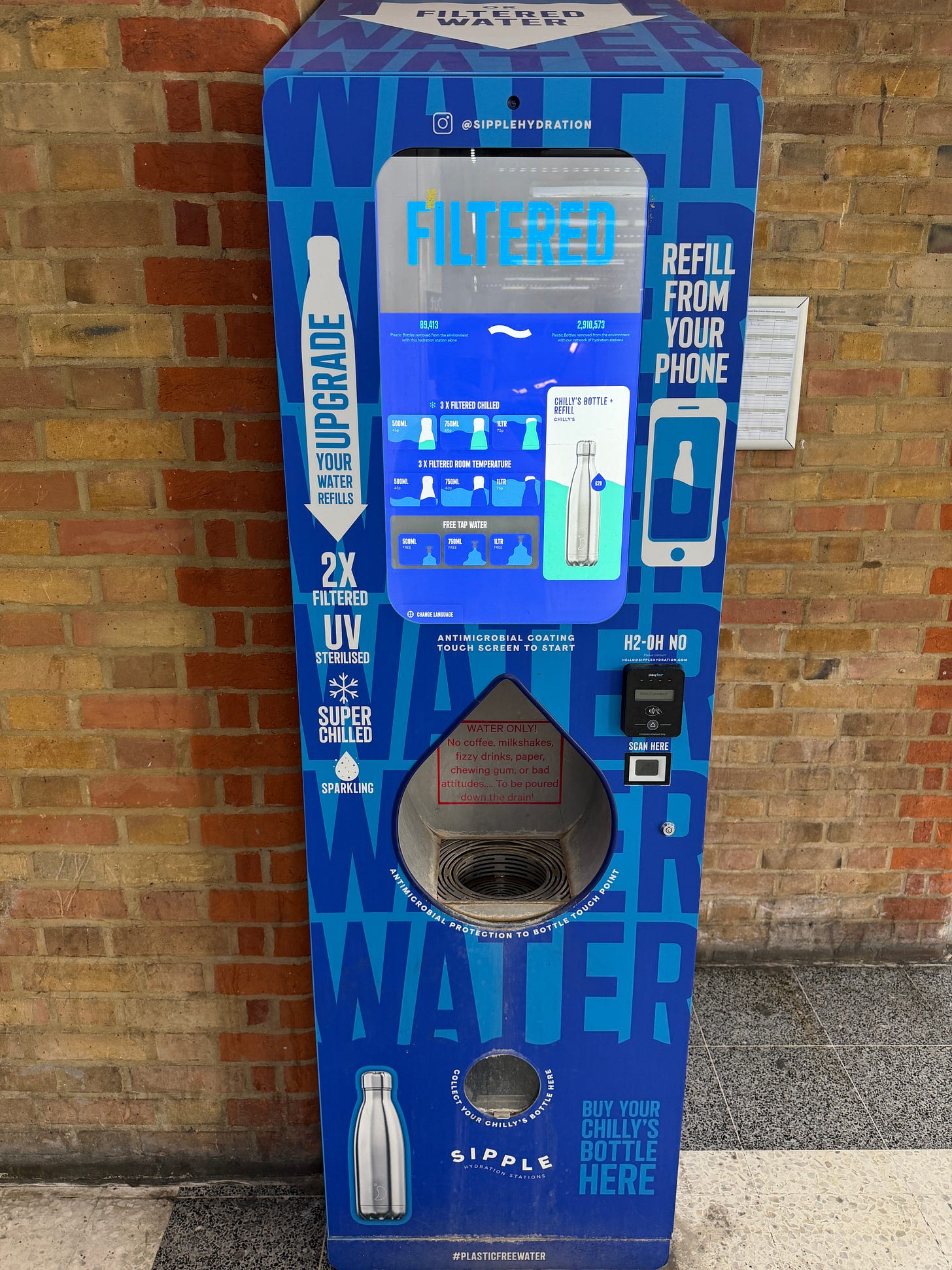 Photo of a high tech water dispensing machine with touch screen, branded bottle dispenser and card reader. Photo of a high tech water dispensing machine with touch screen, branded bottle dispenser and card reader.