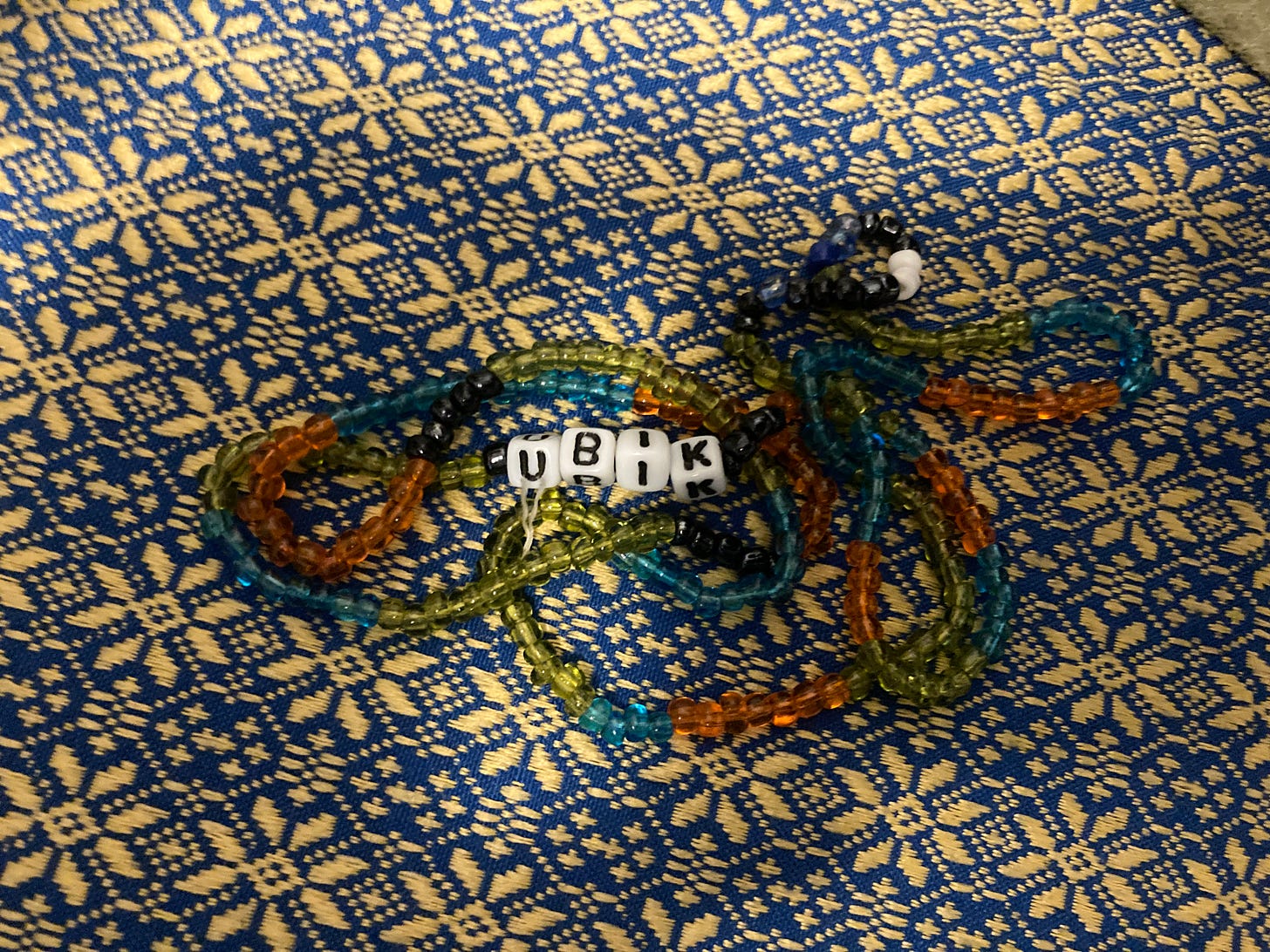 beads on kitchen table. beads say UBIK