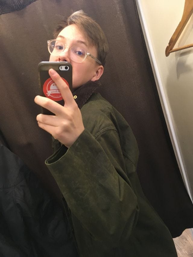 I look into a mirror, holding my phone, posing at an awkward angle I look into a mirror, holding my phone, posing at an awkward angle