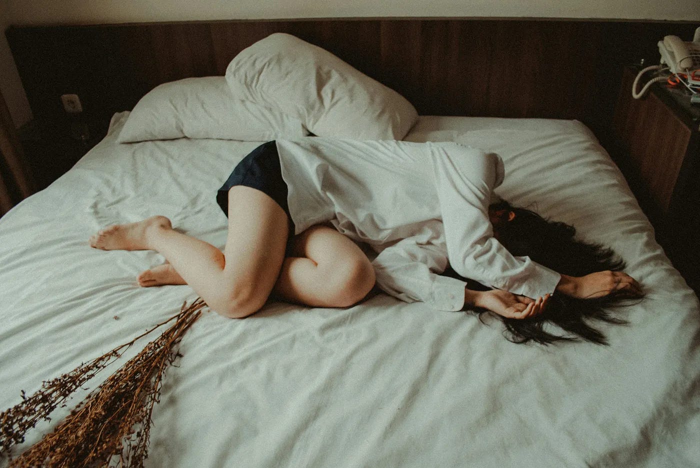 woman in pain on her bed woman in pain on her bed