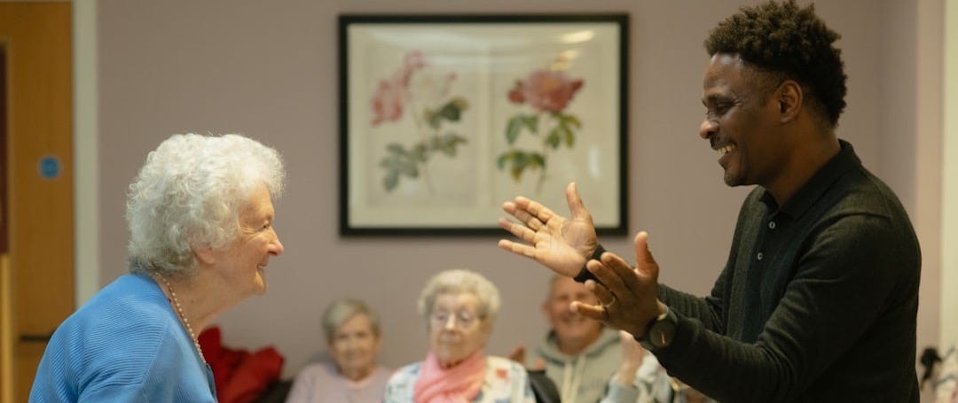 Man clapping hands with an elderly woman. Man clapping hands with an elderly woman.